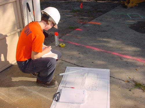 Field Technician examining plans