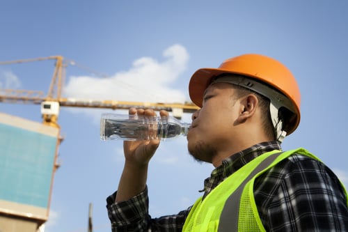 construction worker drinking from water bottle