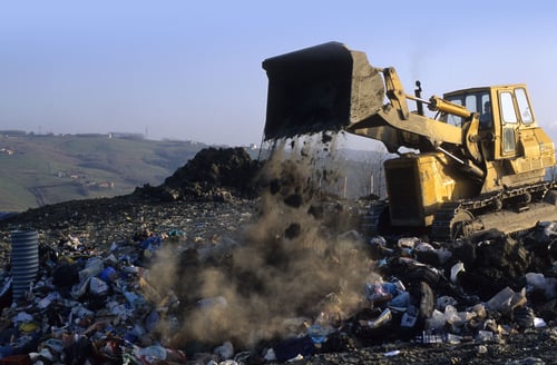 construction vehicle dumping trash