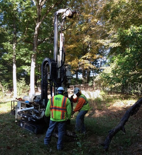 2 construction workers on drill machine